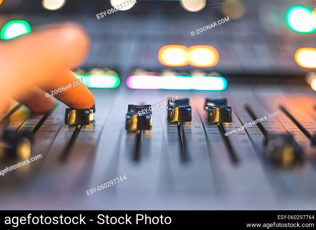 Professional music production in a sound recording studio. Sound engineer is working