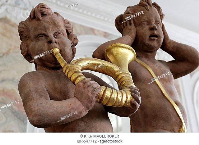 One putto blowing a golden horn, other put hands over the ears, palace of the prince elector, Trier, Rhineland-Palatinate, Germany