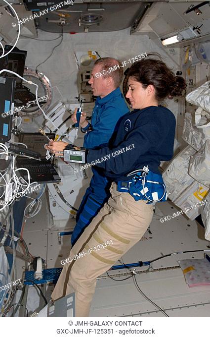 NASA astronaut Nicole Stott and European Space Agency astronaut Frank De Winne, both Expedition 20 flight engineers, work in the Kibo laboratory of the...