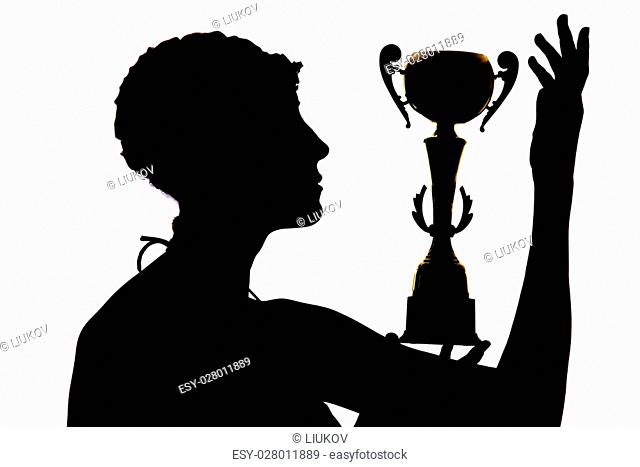 Silhouette of a girl who won the cup for a victory in swimming