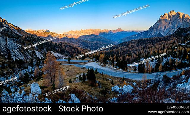Early morning autumn alpine Dolomites mountain in first sunrays. Peaceful panoramic view from Valparola Pass, Belluno, Italy