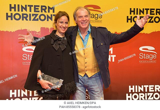 Actor Wolfgang Fierek and his wife Djamila Mendil posing on the red carpet during the premiere of the Udo Lindenberg musical 'Hinterm Horizont' (lit