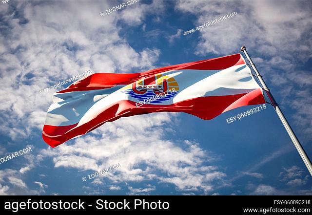 Beautiful national state flag of Polynesia fluttering at sky background. Low angle close-up Polynesia flag 3D artwork