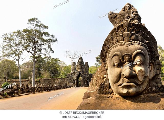 Face of an Asura statue, South Gate of Angkor Thom, Avalokiteshvara face tower, Gopuram, demons balustrade on the bridge, Angkor Thom, Siem Reap, Cambodia