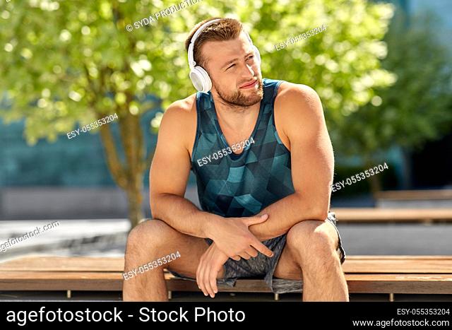 man in headphones listening to music outdoors