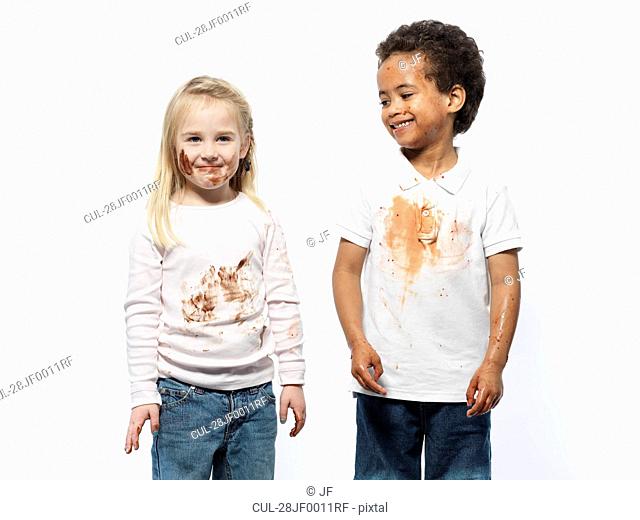 Two kids covered in chocolate sauce