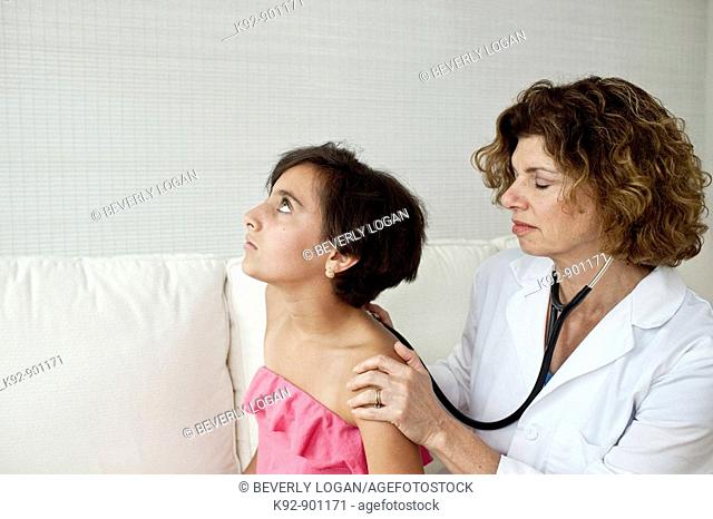 Doctor examining teenager
