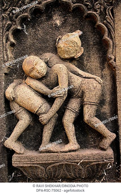 Two wrestlers , carved on the wall of Ahilayabai temple , ornamental carving over stone , old Indian sculpture , Heritage site