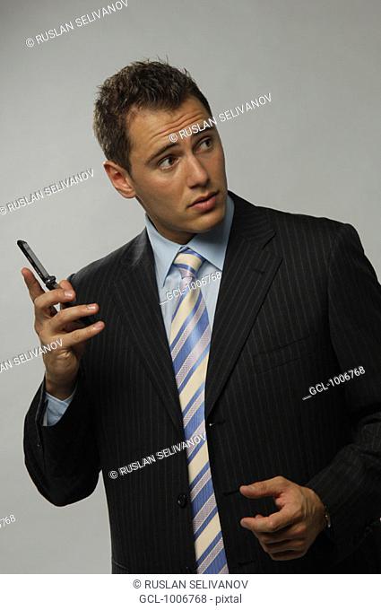 Businessman holding mobile phone in his hand
