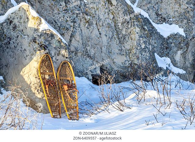 winter landscape with sandstone rocks and classic Bear Paw snowshoes