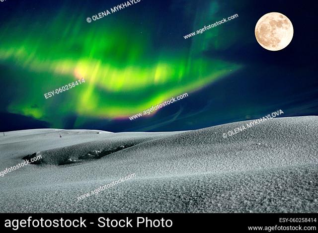 Aurora borealis over frosty winter night field with fool moon in the sky