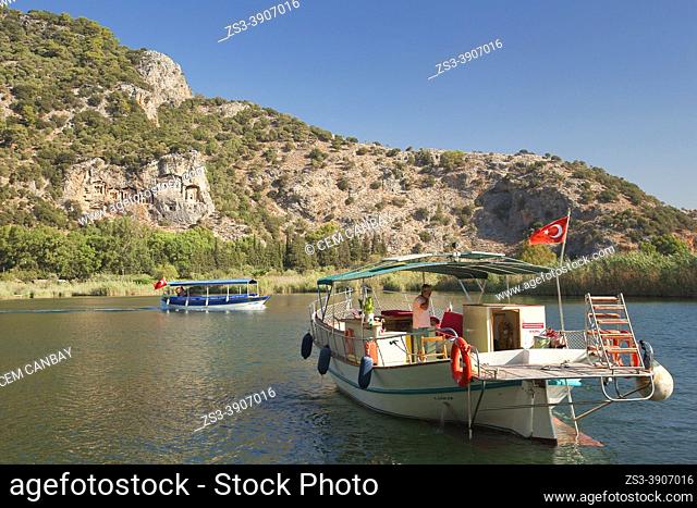 Touristic river boats on Dalyan River with the Lycian rock cut royal tombs of ancient Kaunos city at the background, Dalyan, Mugla Province, Aegean Region