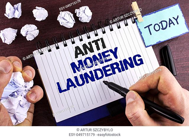 Text sign showing Anti Monay Laundring. Conceptual photo entering projects to get away dirty money and clean it written by Man Notepad holding Marker wooden...