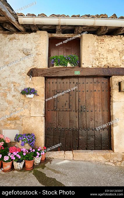 Detail of the wooden door and flowers in Baquedano, Navarra, Spain, Europe