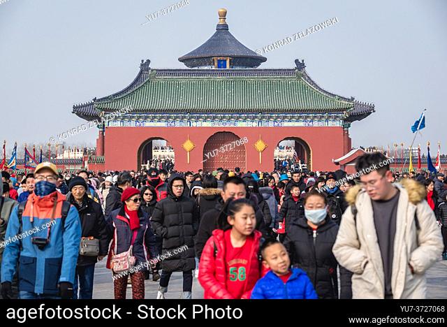 Tourists on Danbi Bridge in Temple of Heaven in Beijing, China - view with roof of Hall of Prayer for Good Harvests