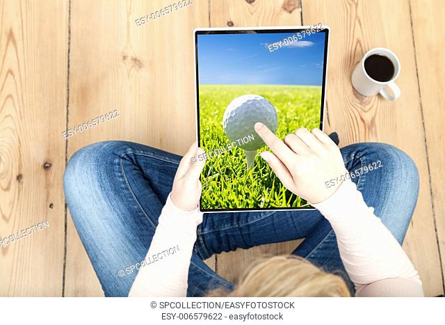 woman pointing on golf ball on tablet