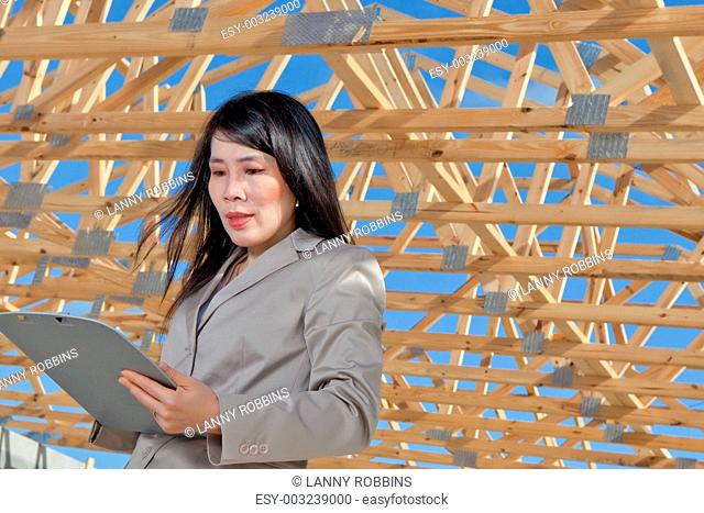 Asian woman contractor with a set clipboard