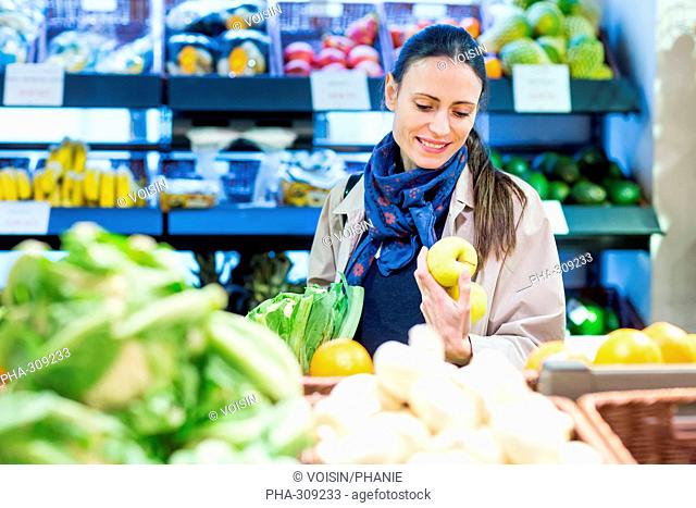 Woman shopping for fruits in a supermarket