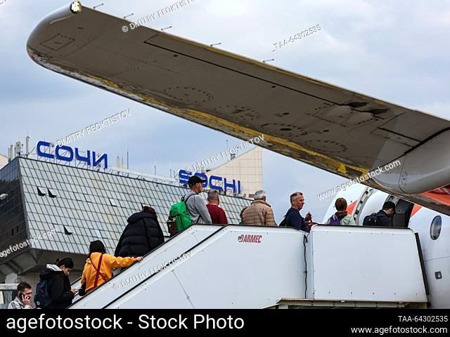 RUSSIA, SOCHI - NOVEMBER 2, 2023: Passengers board a Sukhoi Superjet 100 plane operated by Azimuth and bound for Tel Aviv at Sochi International Airport named...