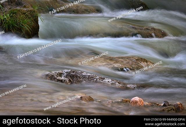 10 June 2021, Bavaria, Halblech: With strong current the water of the mountain river Halblech flows (long exposure). Because of the heavy rainfalls in the last...