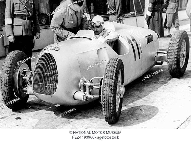 Ernst von Delius in Auto Union Car, 1936. Von Delius consults with a member of his pit crew, probably at the 1936 Eifelrennen race at the Nurburgring