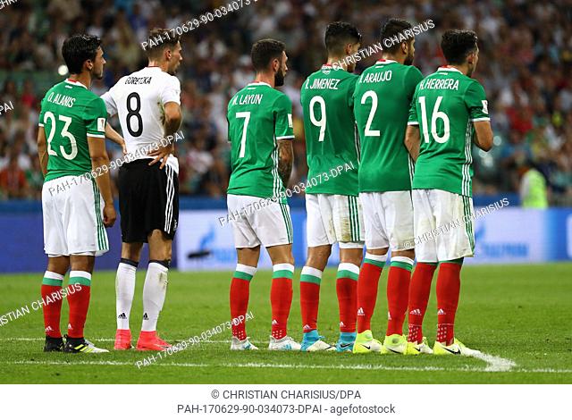Germany's Leon Goretzka stands next to Mexico's Oswaldo Alanis (L-R), Miguel Layun, Raul Jimenez, Nestor Araujo and Hector Herrera during the semi-final of the...
