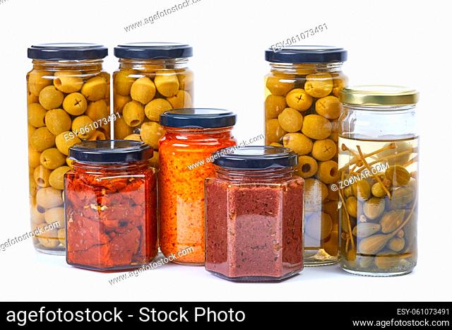 Jars of olives, pesto, dried tomatoes, caper isolated on white background