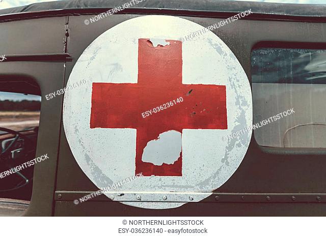 Close up of a red cross on a vintage old army ambulance