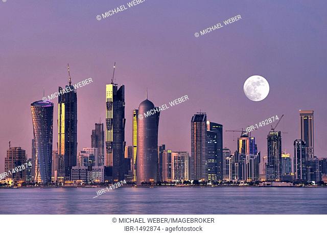 Skyline of Doha, Tornado Tower, Navigation Tower, Peace Towers, Al-Thani Tower, at dusk, Qatar, Persian Gulf, Middle East, Asia