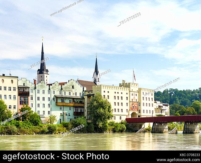 The Rote Bruecke (red bridge) crossing river Inn and the town gate Brucktor. The medieval old town of Wasserburg am Inn in the Chiemgau region of Upper Bavaria