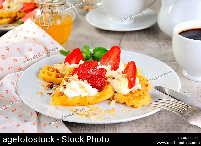 Delicate, melting mouth-watering Belgian waffles with whipped cream, strawberries, flavored with peanuts and honey. What could be better for breakfast