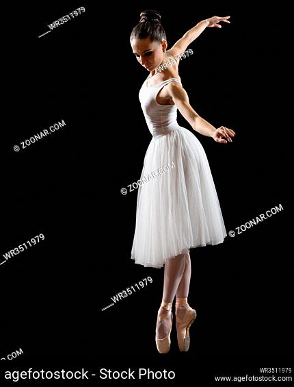 Young ballerina isolated on black