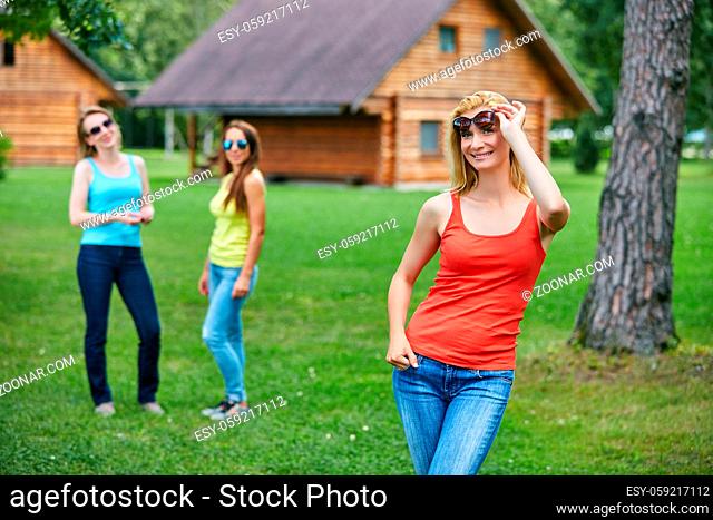 three beautiful young women spending time ourdoors in countryside. friends having fun. Outside shot. Copy space