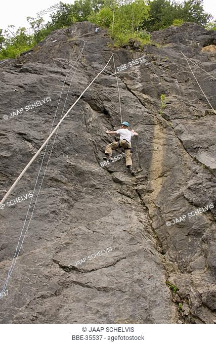 Climber on steep rock surface