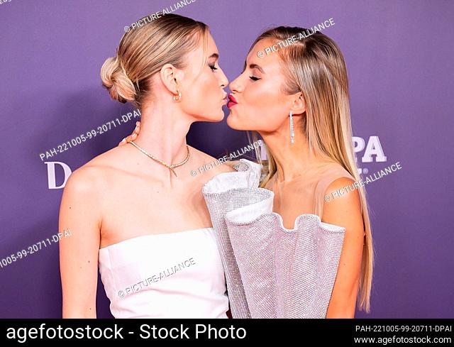 05 October 2022, Berlin: Kim Hnizdo (l) and Alena Gerber, both models, arrive at the ""Tribute to Bambi"" charity event. The aim of the Hubert Burda Media event...