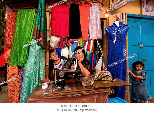 Indonesian dressmaker on her sewing machine