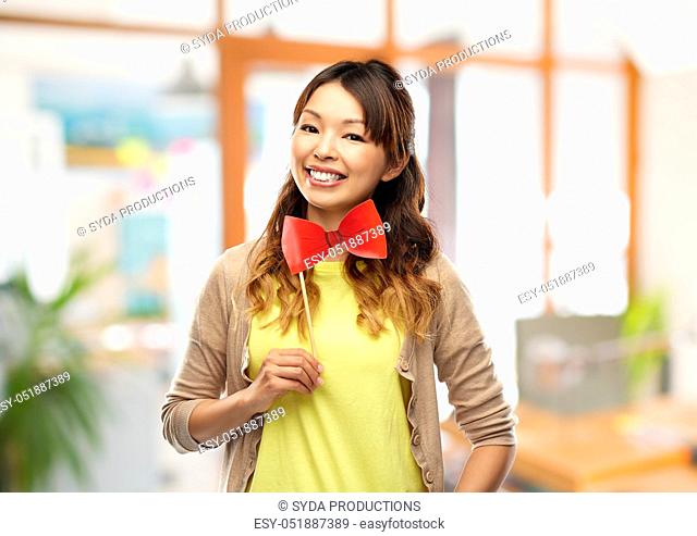 happy asian woman with big red bow tie