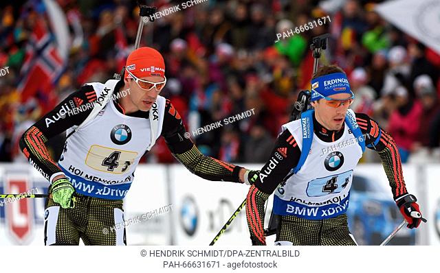 Biathlete Arnd Peiffer (L) changes to Simon Schempp of Germany during the Men's 4x7.5 km relay competition at the Biathlon World Championships
