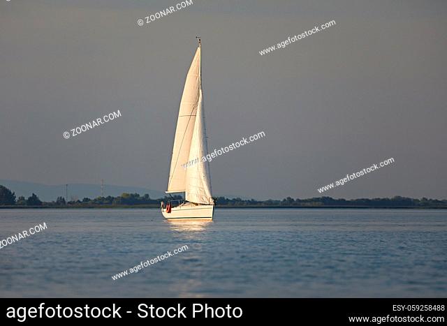 Sailing boat on the water it the evening