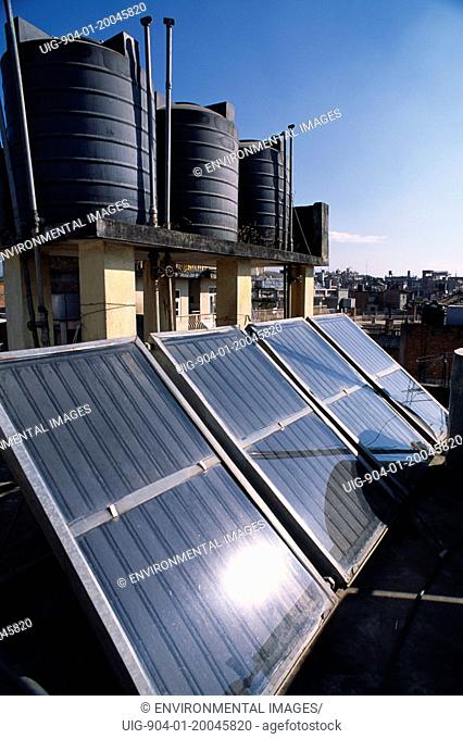 NEPAL Kathmandu Locally produced solar water heaters on rooftops with black hot water reservoirs.