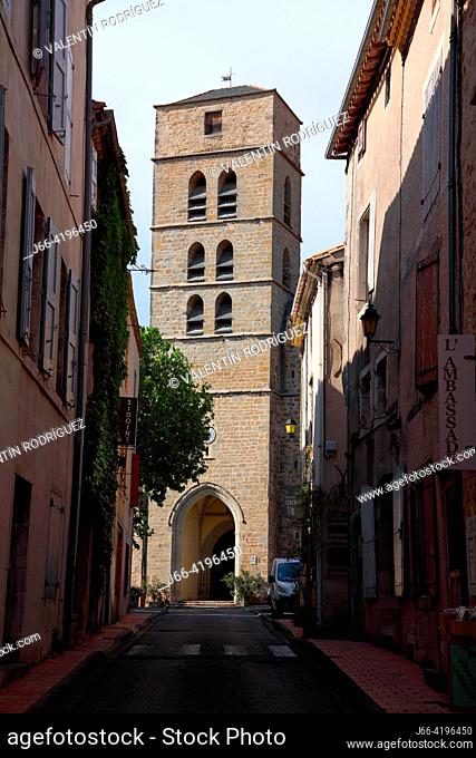 Street in Montolieu, ""the village of books"", with its church at background. France