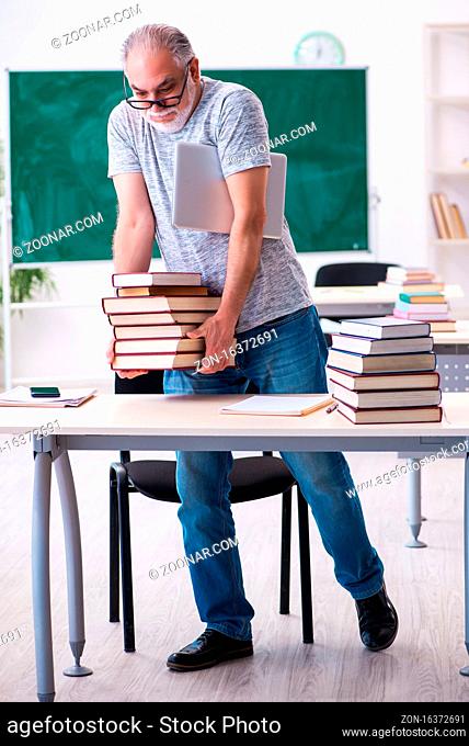 Senior male student preparing for exams in the classroom