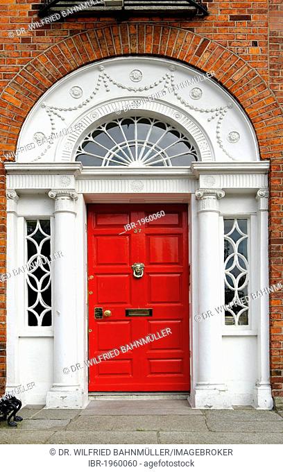 Red front door of a terraced house near Merrion Park, Dublin, Republic of Ireland, Europe
