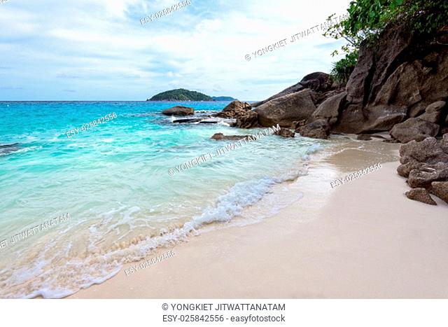 Beautiful landscape of blue sea sand and white waves on small beach near the rocks during summer at Koh Miang island in Mu Ko Similan National Park