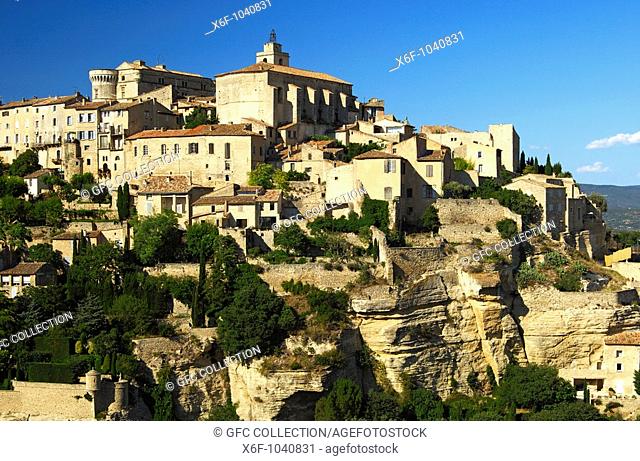 Gordes with the Château de Gordes and the Saint-Firmin church on the Monts de Vaucluse hill, Provence, France