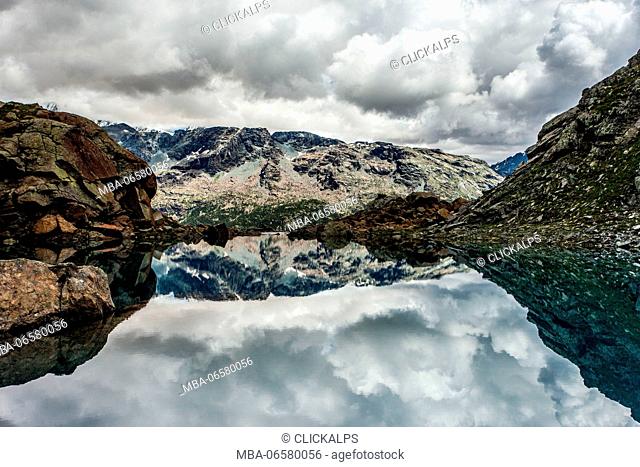 Clouds are reflected in thelake of lagazzuolo in Malenco valley, Lombardy, Italy, Europe