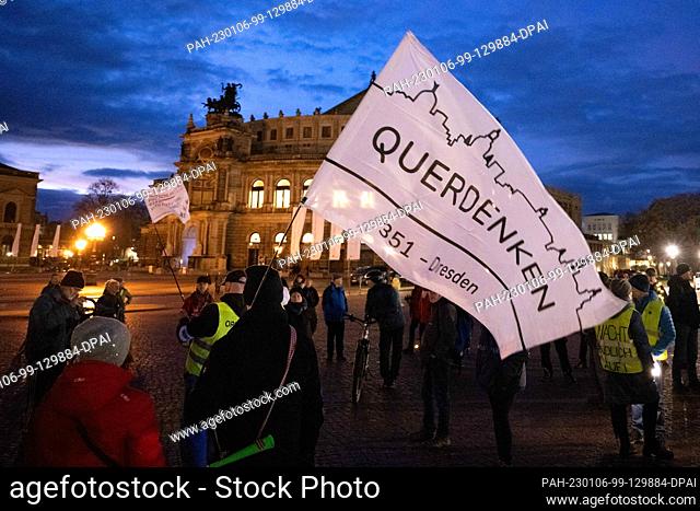 06 January 2023, Saxony, Dresden: Participants in a demonstration of employees from nursing and health care professions stand on Theaterplatz in front of the...