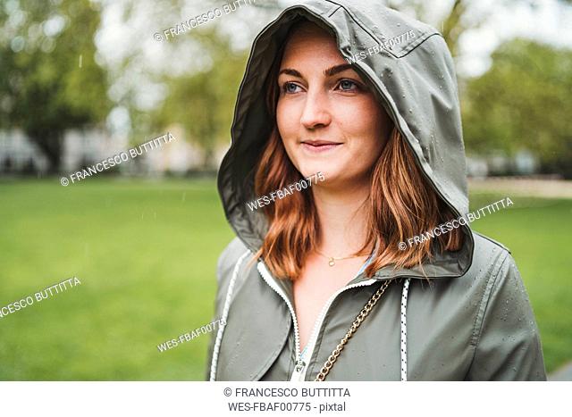Young woman wearing hooded jacket on a rainy day