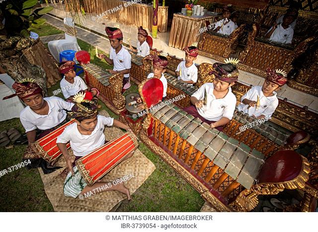 Children and teenagers of a gamelan orchestra at an event, Ubud, Bali, Indonesia