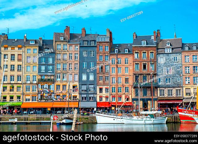 Honfleur, Normandy, France - 26 March 2019: The old port of Honfleur, Normandy, France, showing the colorful old houses and the many boats and yachts